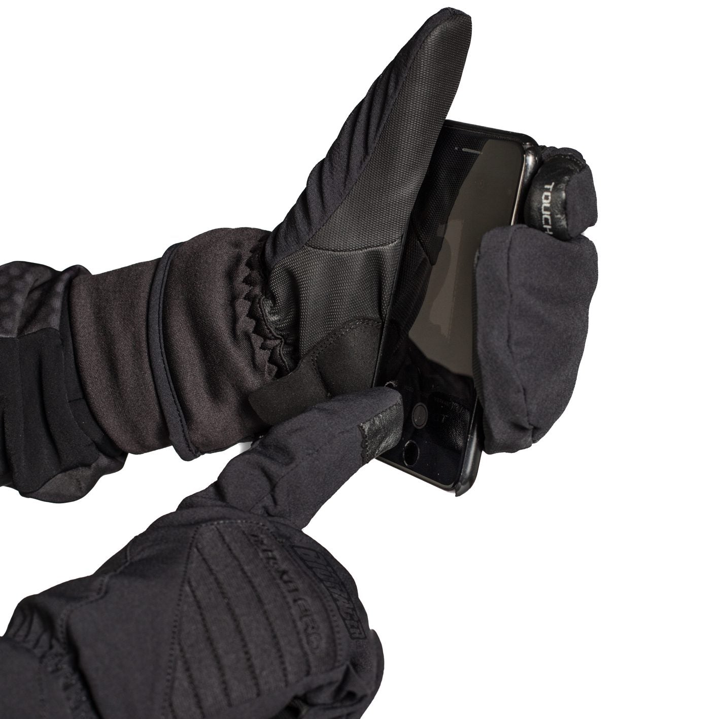 Cyclist wearing black Bioracer Alaska Pro Winter Gloves operating a smartphone with touchscreen-compatible fingertips.