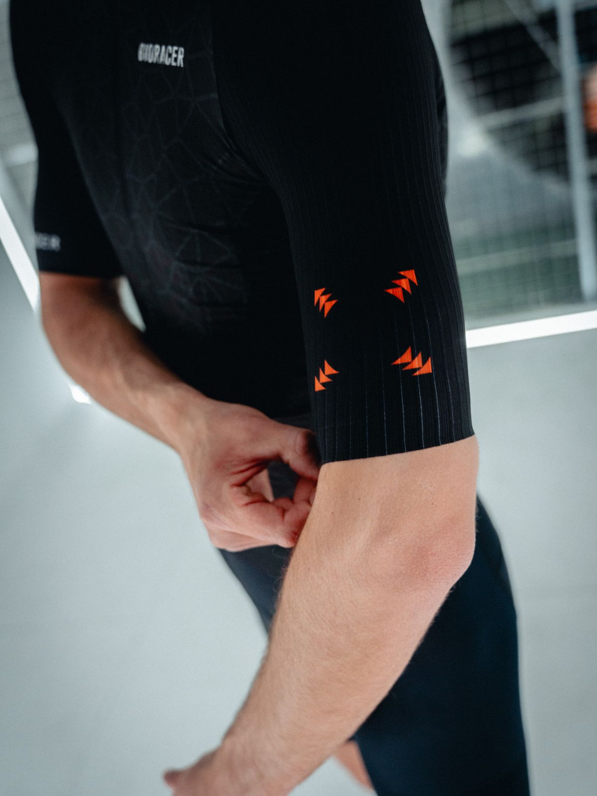 Close-up of Bioracer Speedwear Graphene black jersey sleeve with CleanCut finish and aerodynamic fabric texture