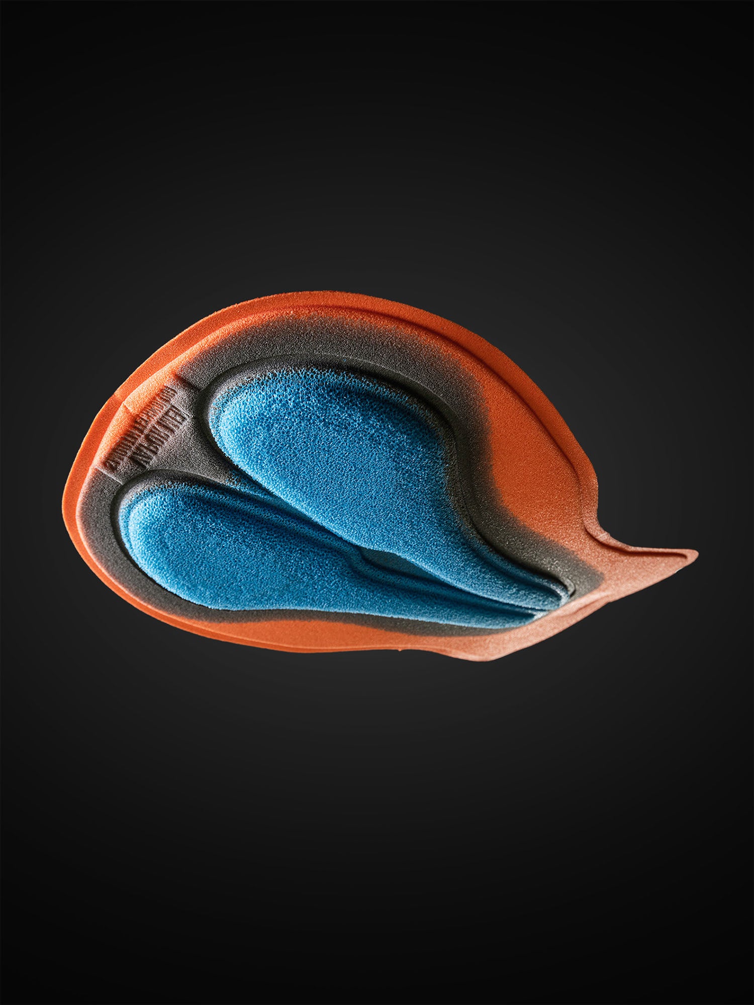 Close‑up of Bioracer Vapor cycling pad in multi‑density foam with breathable perforations and moisture‑managing EVAPOR webbing