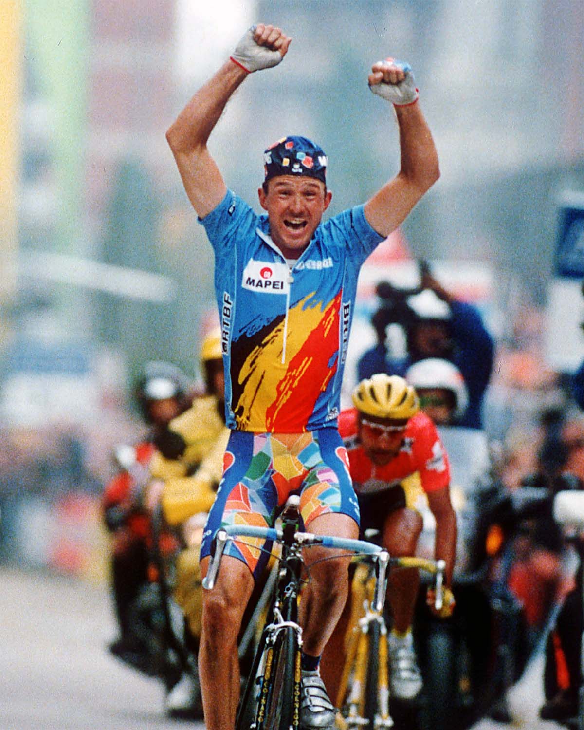 Johan Museeuw celebrates victory in his iconic Mapei kit during a historic race finish, symbolizing Bioracer’s legacy in elite cycling with over 1300 medals and 532 titles won worldwide